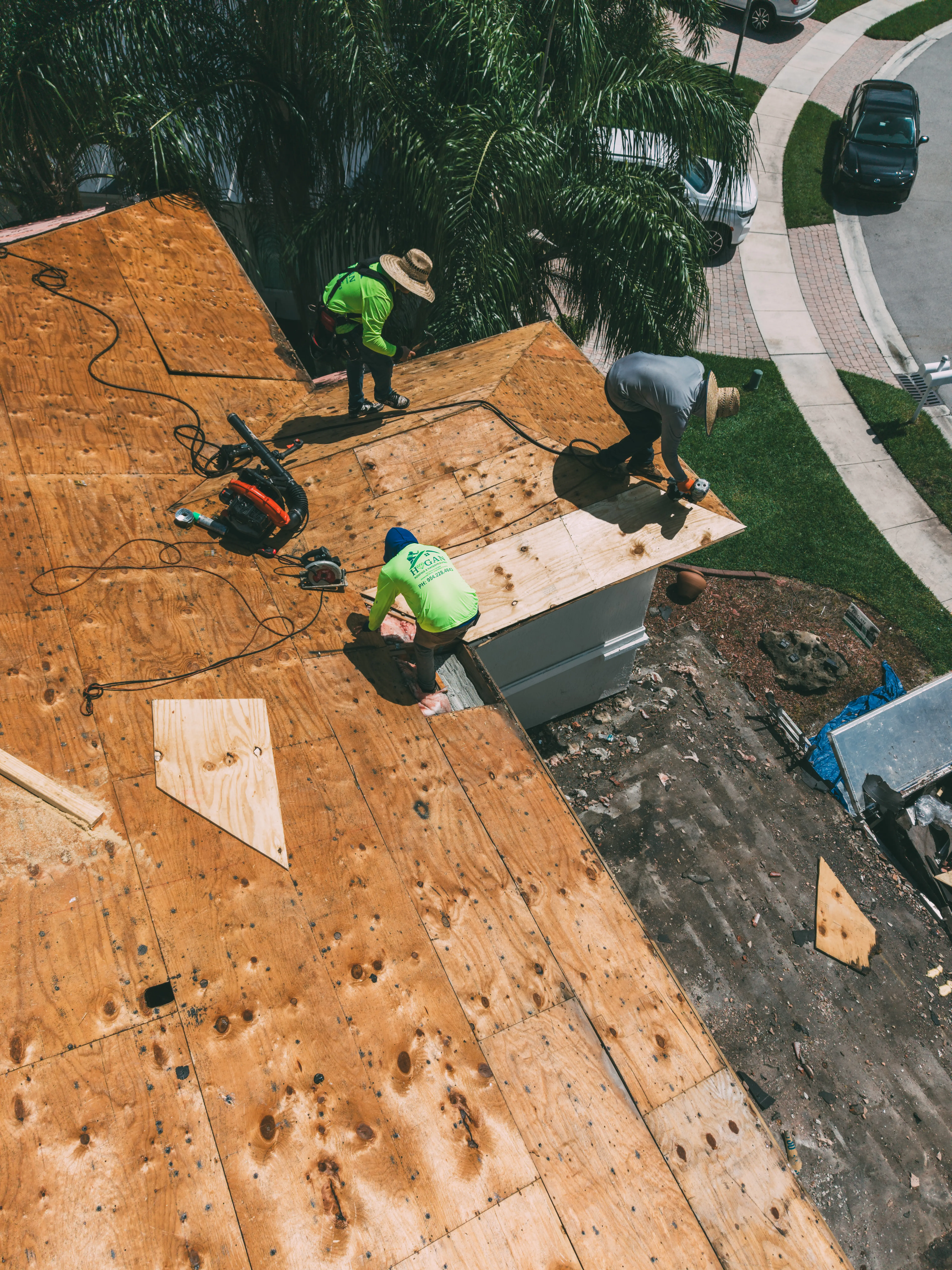 Three Hogan crew members standing on a shingle ridge